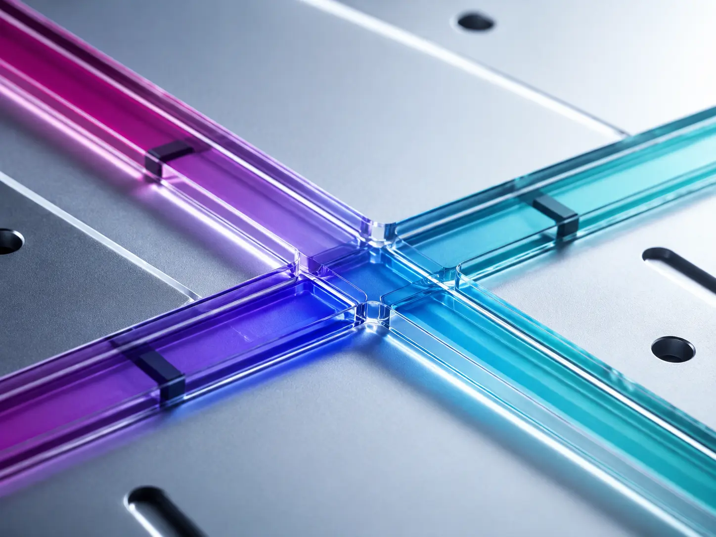 Transparent violet and cyan microfluidic channels crossing on a silver instrument plate